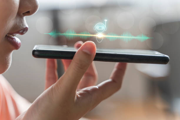Person speaking into a smartphone with a voice assistant robot icon
