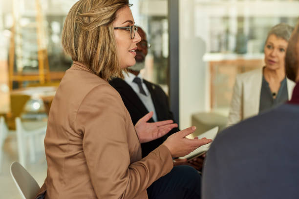 Two women discussing payroll cutoff calendar in an office