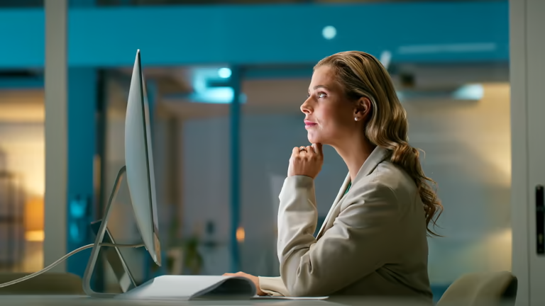 Woman looking thoughtfully at a screen