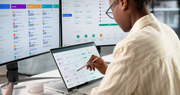 Person using a dual-monitor setup with a tablet