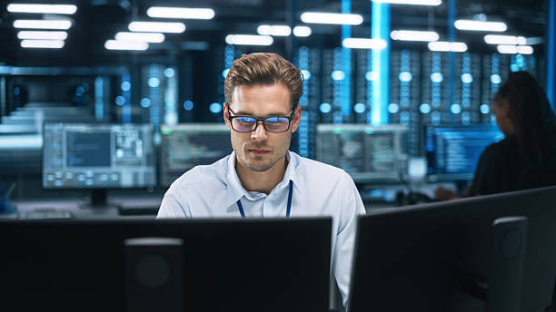 Man working at computers tracking piece-rate work