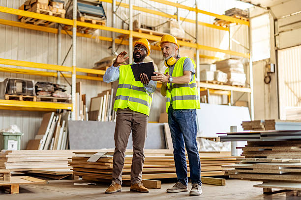 Two workers in a warehouse looking at a tablet