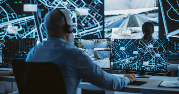 Man working at multiple monitors tracking data