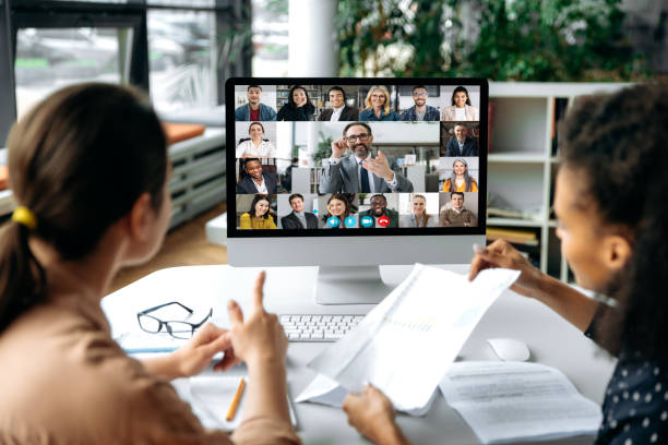 Person looking at a computer screen showing a team video meeting