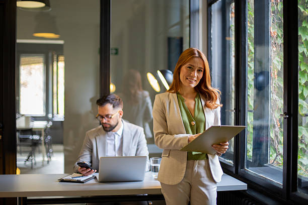 Woman smiling holding a tablet in office