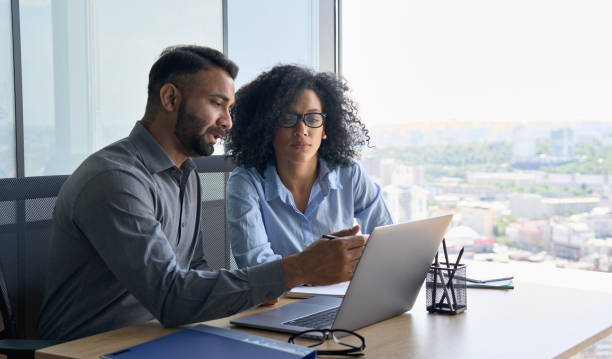 Man and woman looking at a laptop