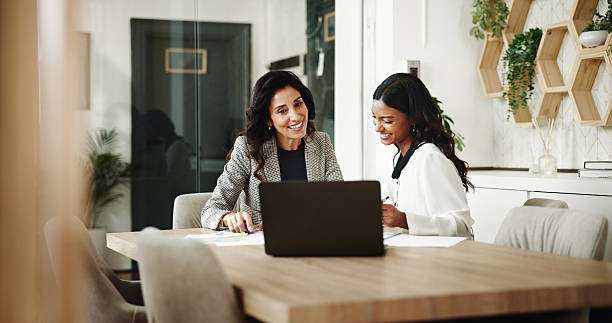 Colleagues looking at a laptop together