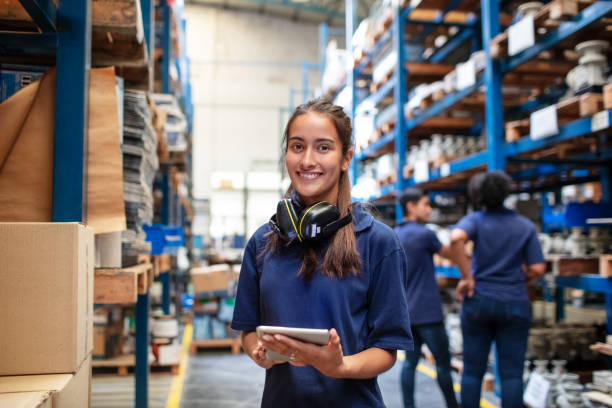 Woman in warehouse looking at tablet