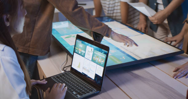 People looking at a laptop showing a route/map