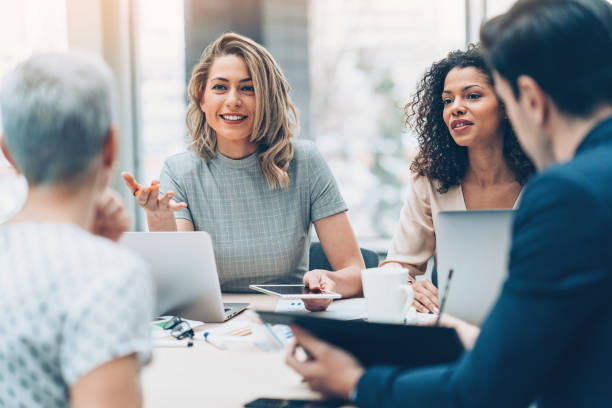 People in an office setting, one woman smiling