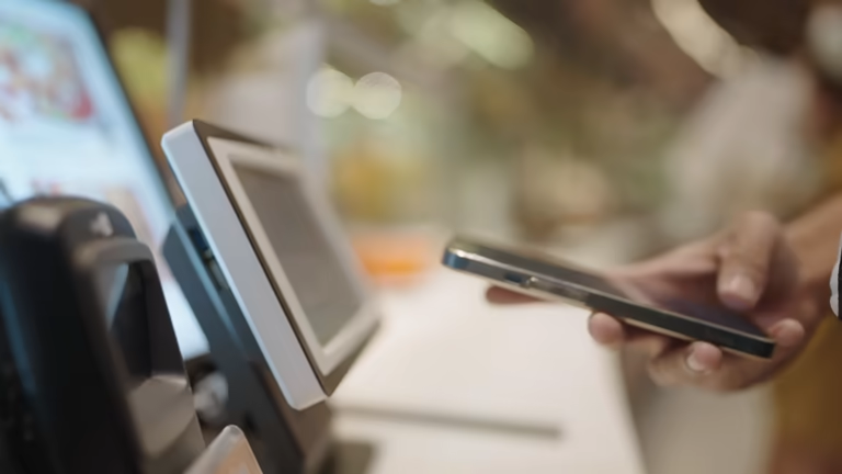 Person scanning phone over terminal