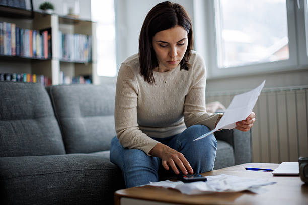 Woman looking at papers on a couch