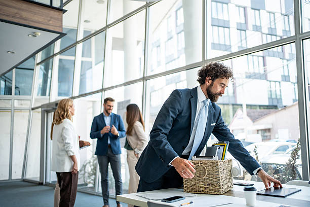 Business professional packing a box in a modern office