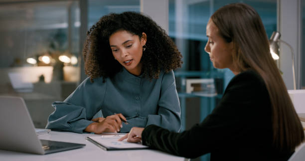 Two people looking at a laptop