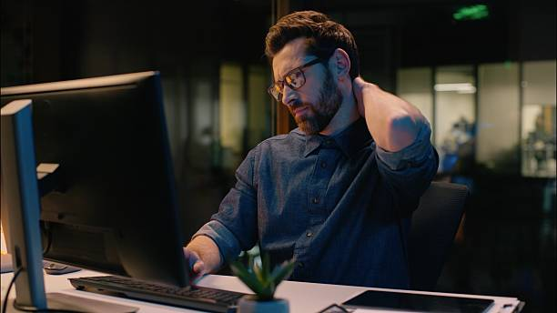 Stressed employee working overtime