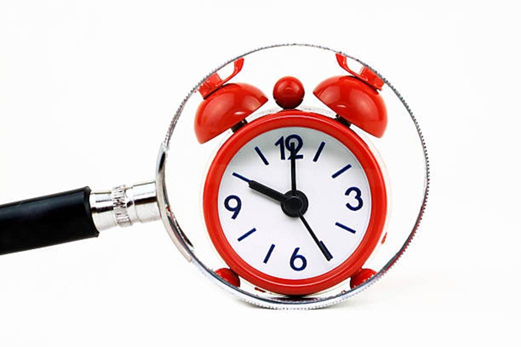 AI time tracking concept with red clock and magnifying glass