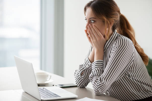 Stressed employee looking at laptop screen