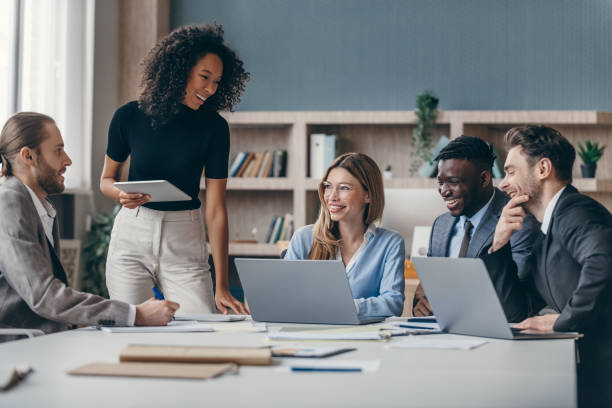 Group of office workers looking at a laptop