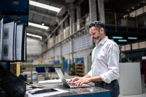 Employee working on laptop in a warehouse