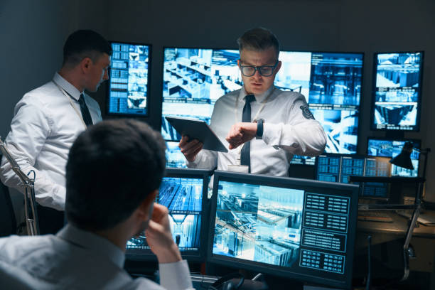 Men looking at multiple computer screens