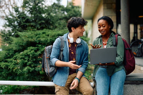 Students using laptop outdoors representing the future of attendance management