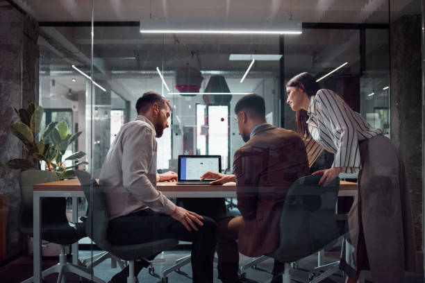 Colleagues discussing timecard data in a meeting room