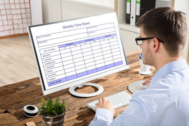Man looking at a Weekly Time Sheet