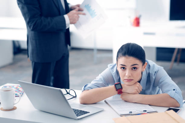 Tired woman looking at her watch due to poor shift planning