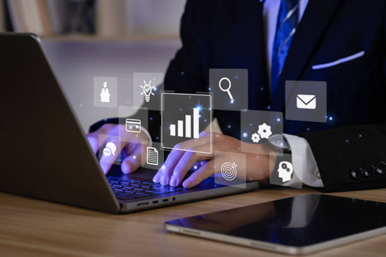 Business analytics dashboard icons over a laptop