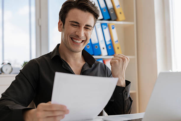Man smiling and looking at papers