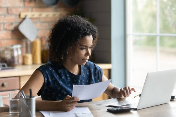 Woman looking at papers at desk