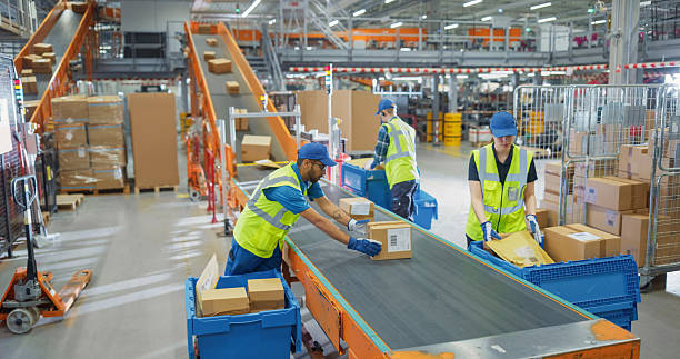 Warehouse workers at a conveyor belt