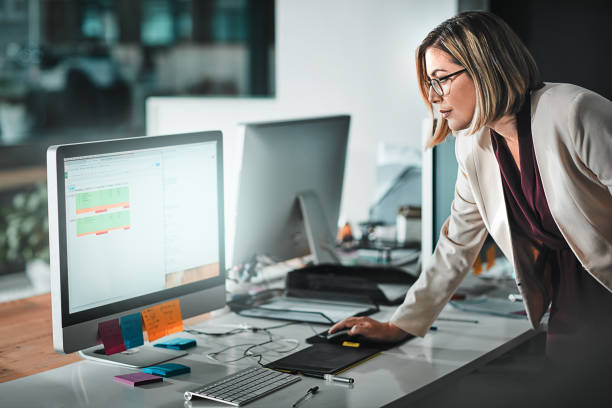 Woman looking at a computer screen ensuring compliance