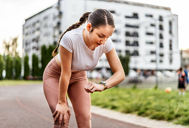 Woman checking her smartwatch on a field