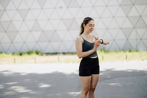 Woman looking at her smartwatch outdoors