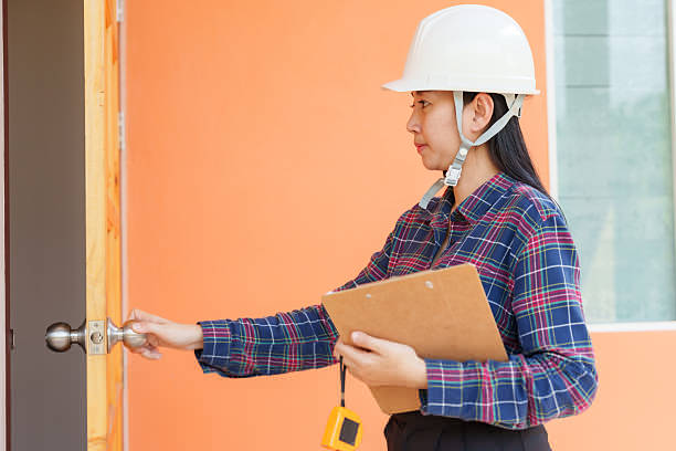 Female construction worker swiping card at door