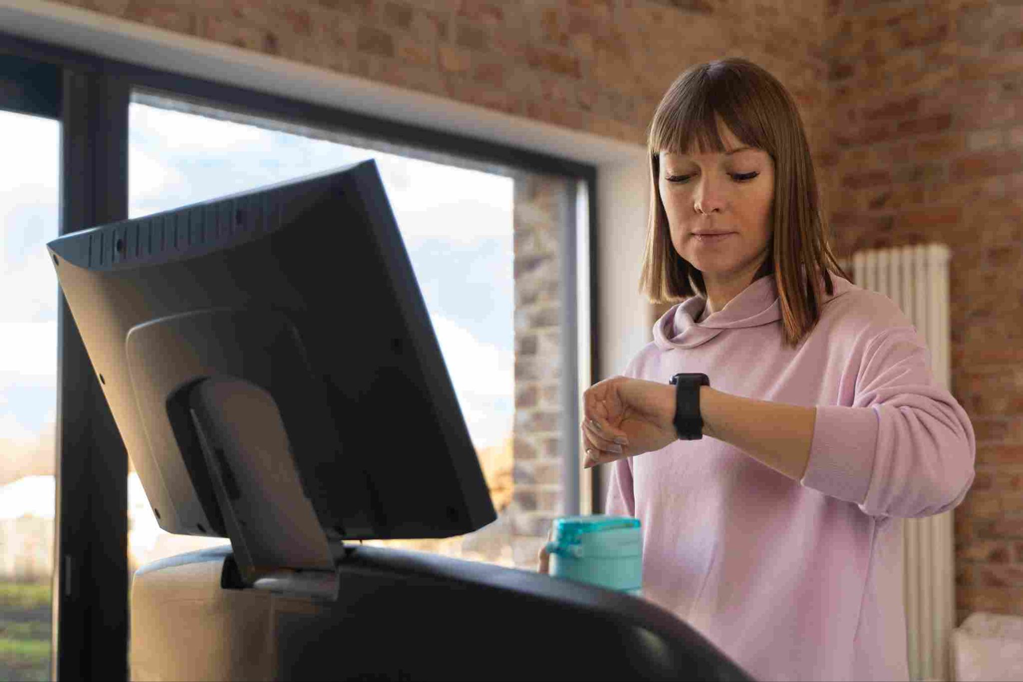 Woman checking her smartwatch for time tracking