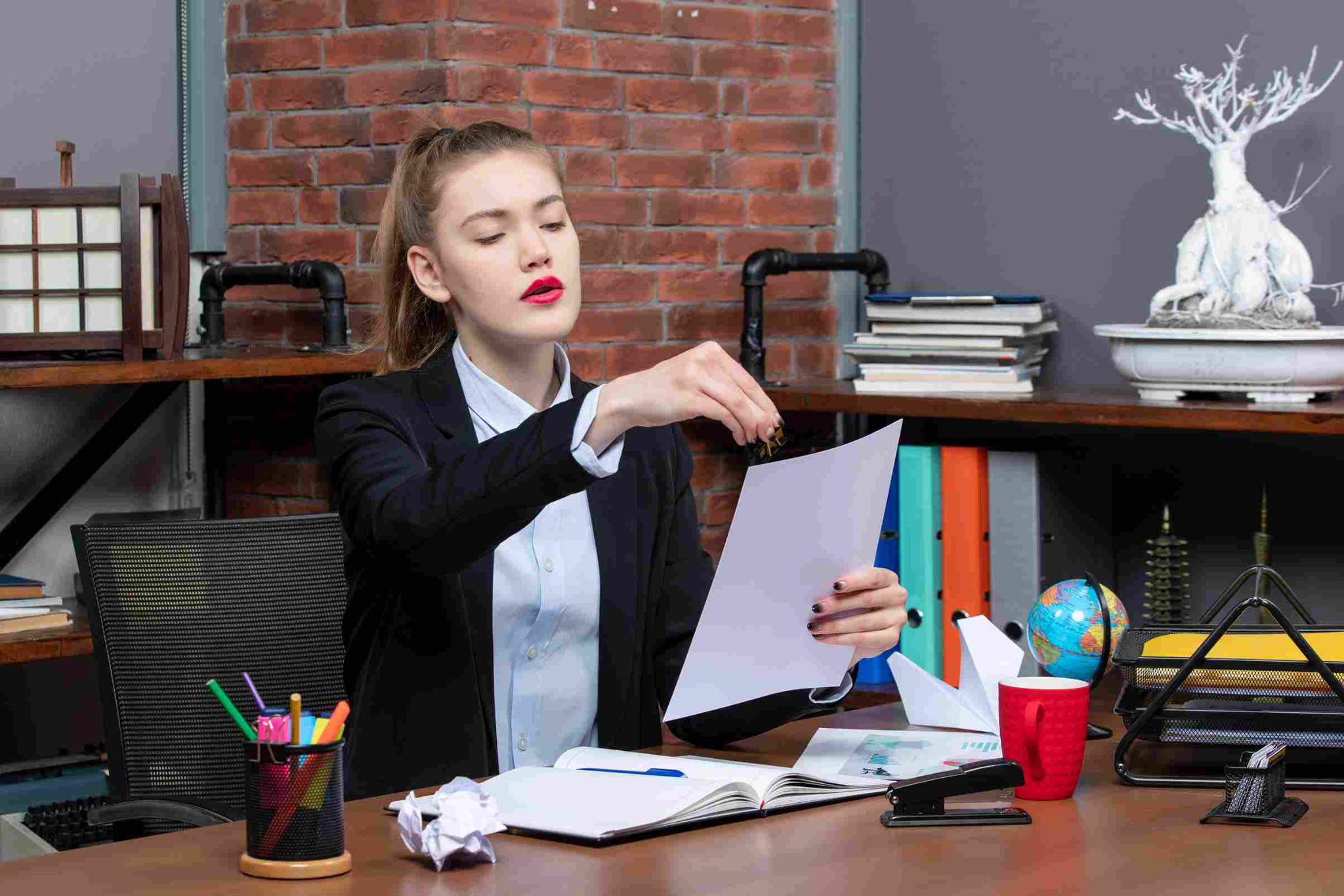 A stressed woman throwing paper
