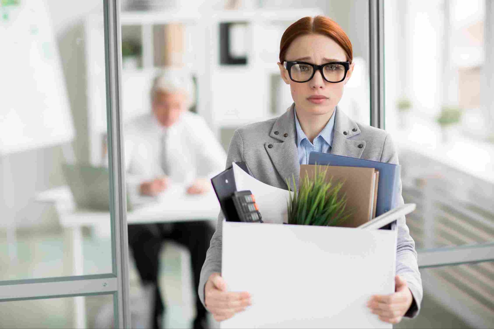 Employee holding a box, appearing stressed or leaving