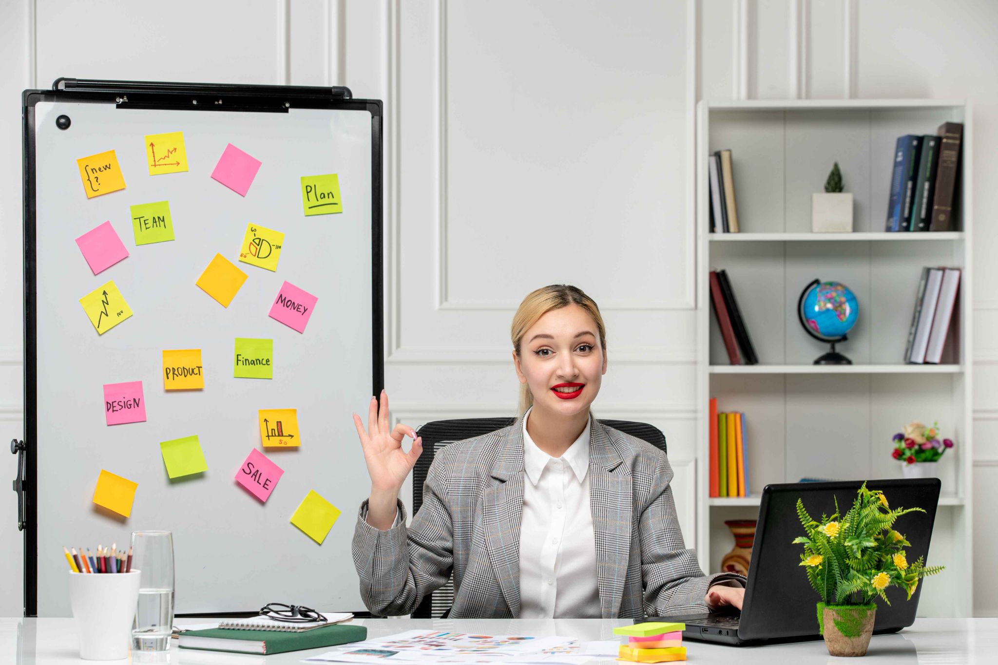 Woman pointing at a whiteboard with sticky notes