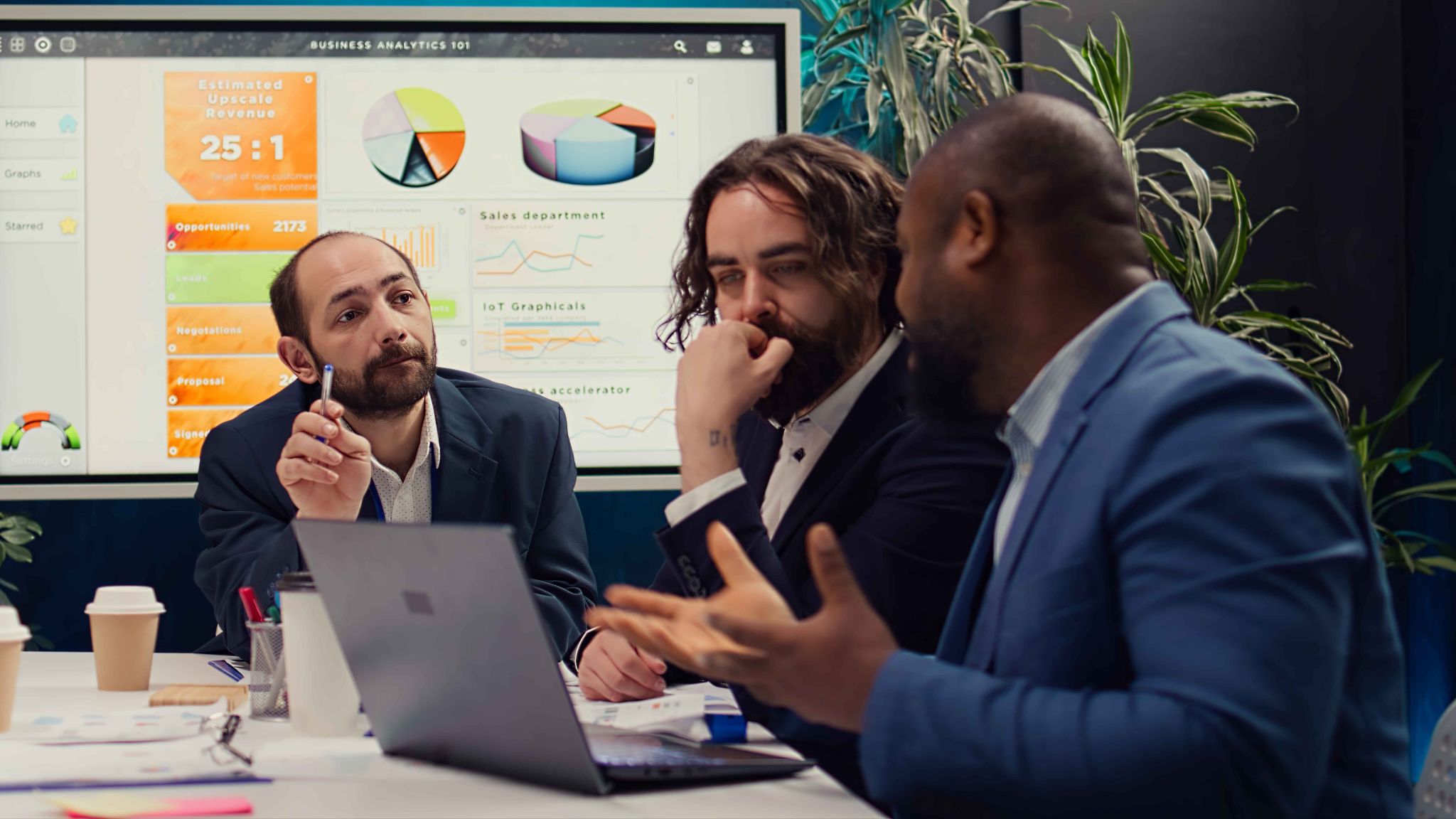 Team analyzing business analytics on a screen