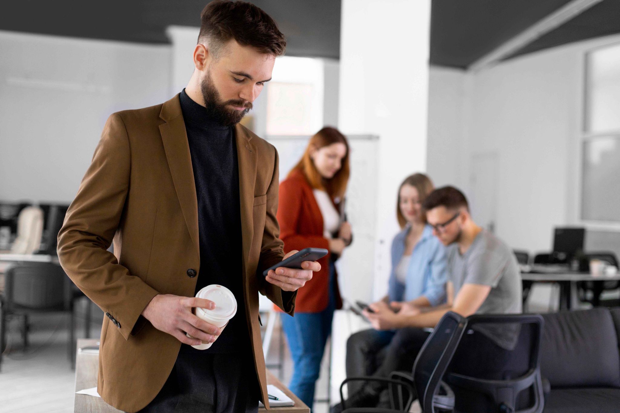 Employees in an office using mobile devices