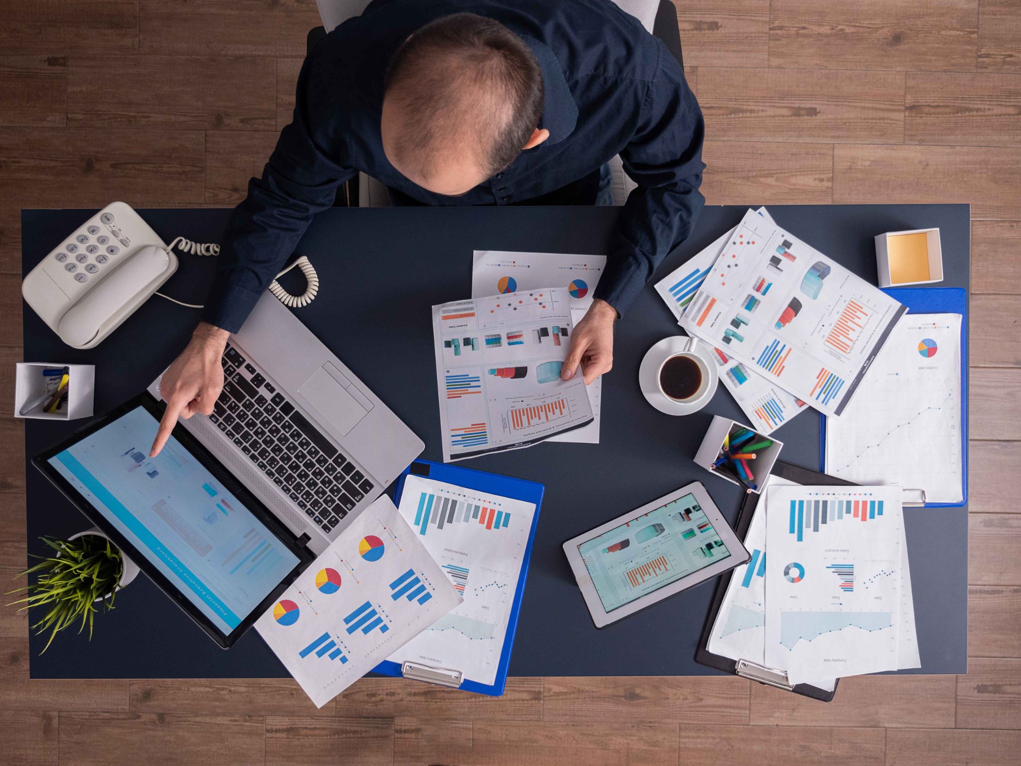 Manager looking at charts on a desk