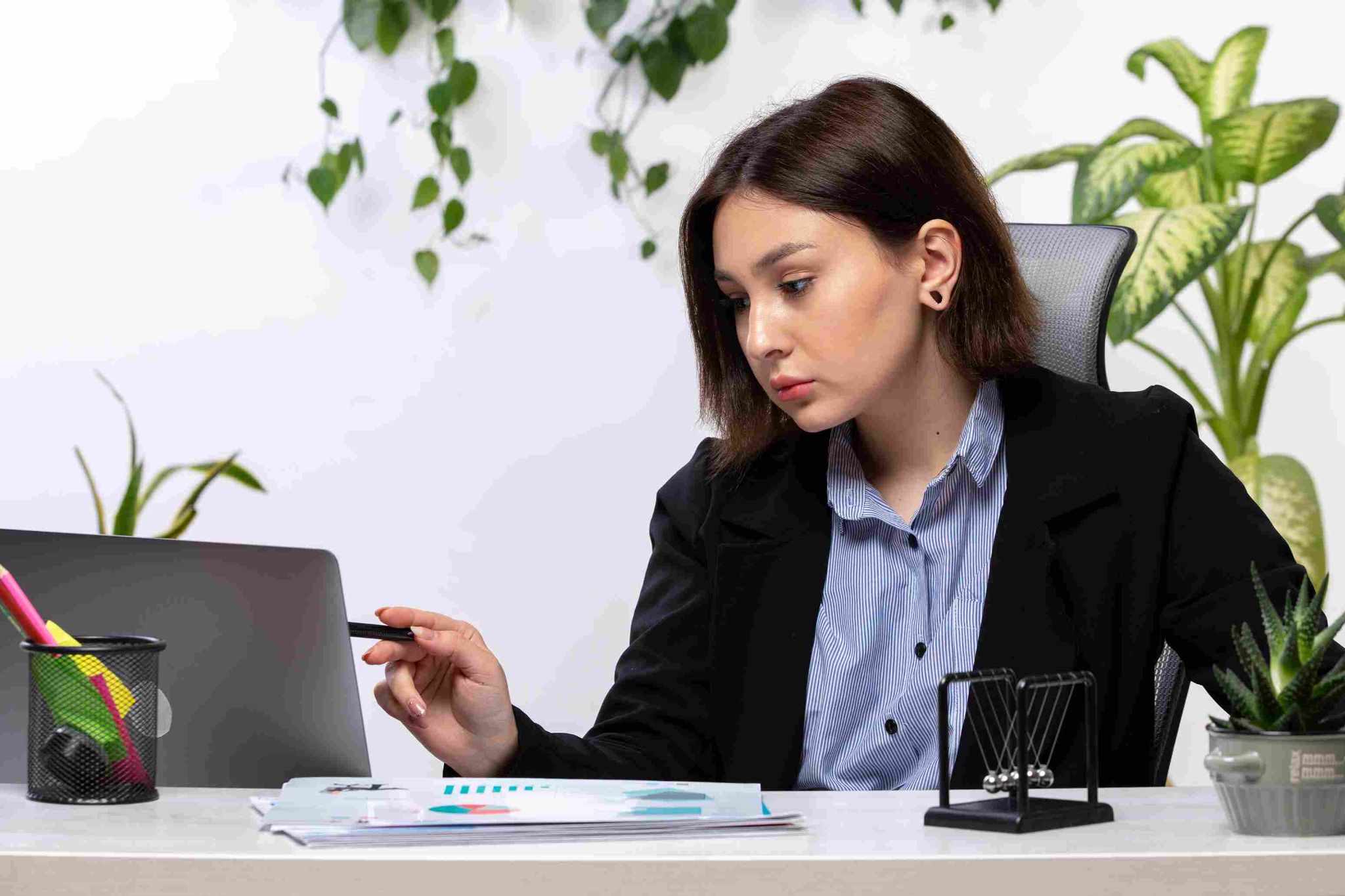 Woman at desk looking at phone
