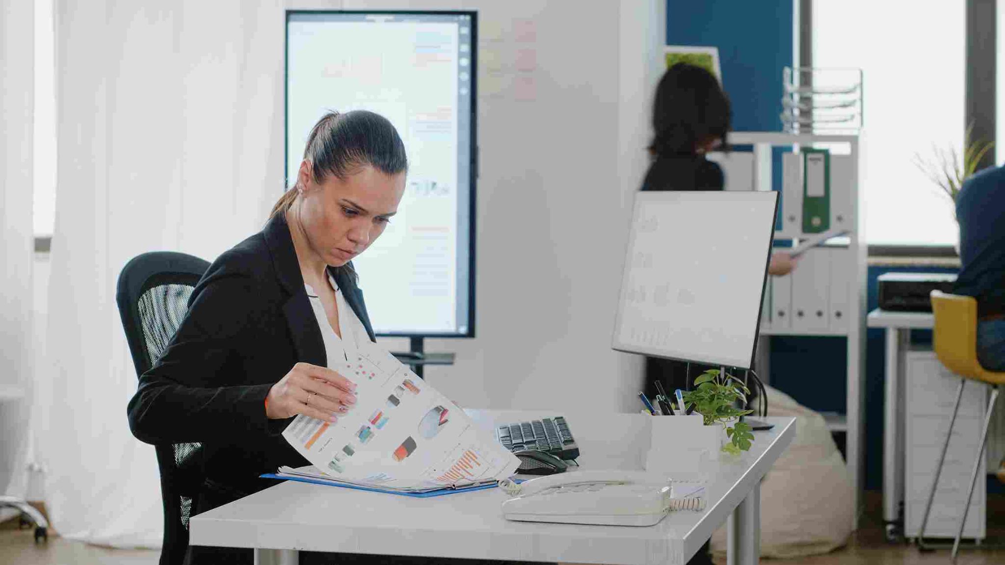 Woman looking at documents at a desk