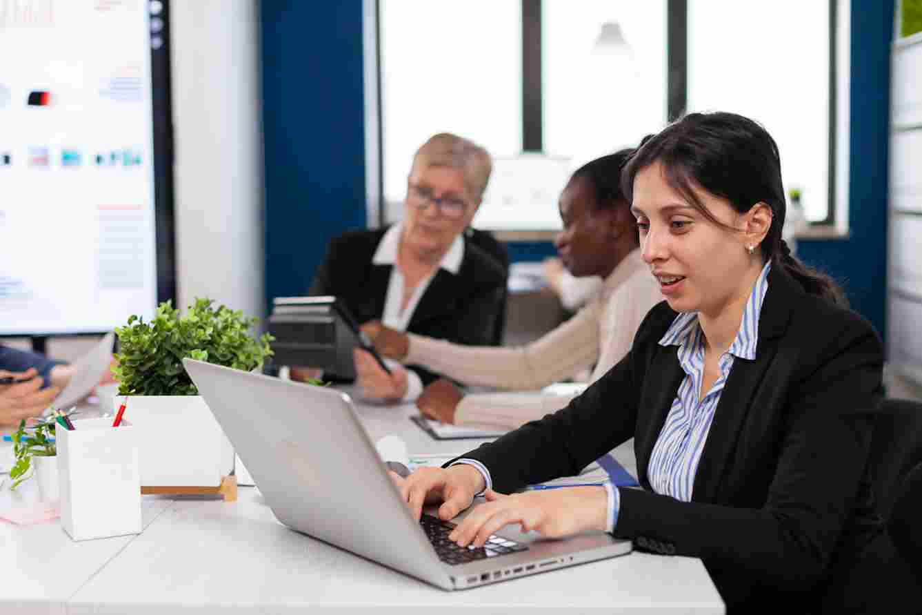 Woman working on a laptop in an office environment