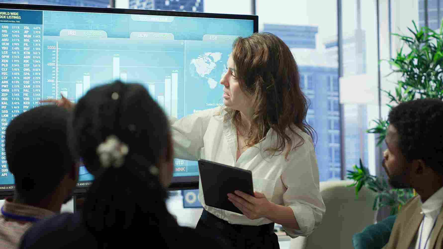 Woman pointing at a screen during a presentation