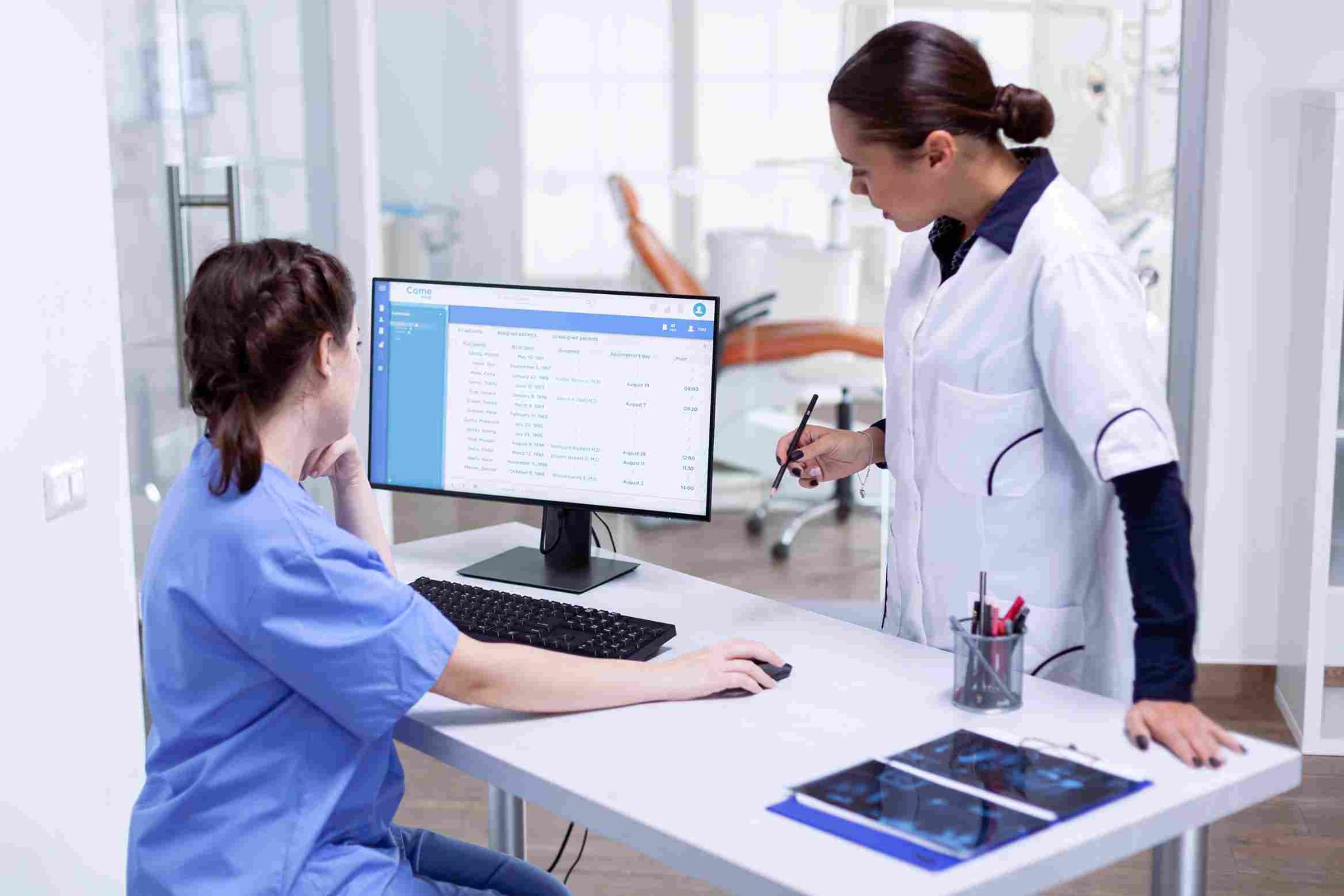 Nurses using scheduling software on a computer