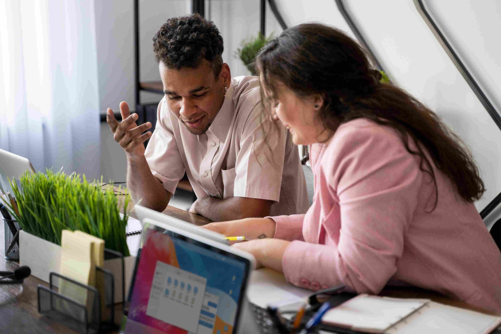 Two people looking at a laptop computer