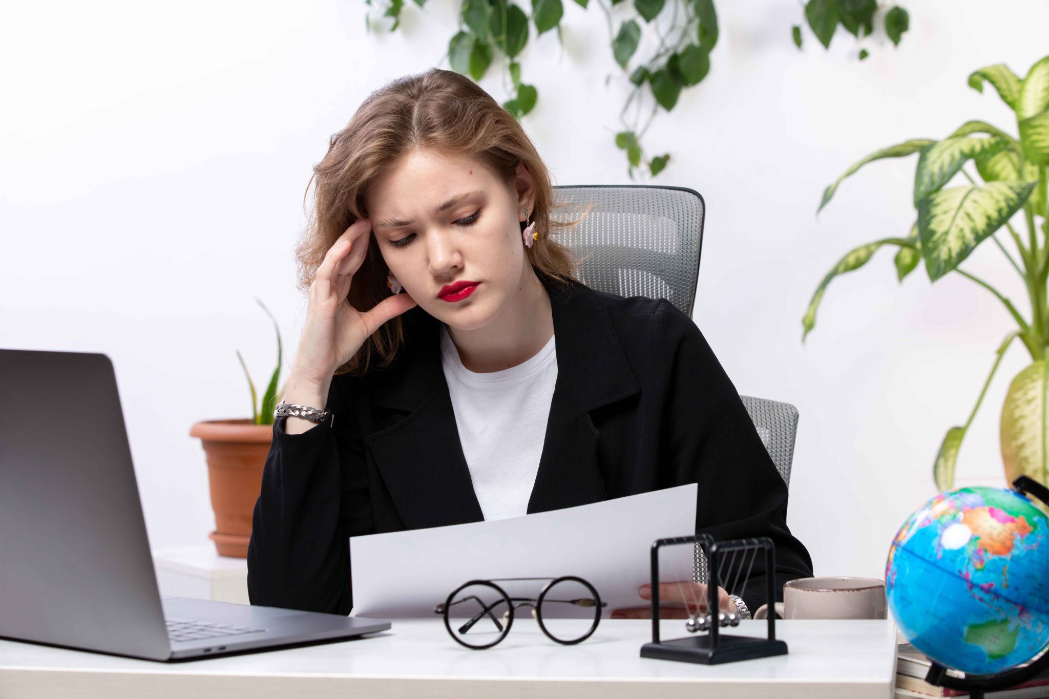 HR professional managing leave paperwork at a desk
